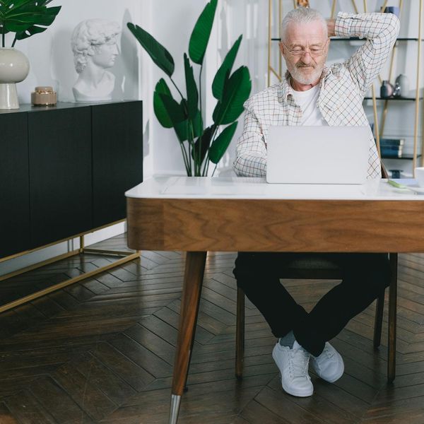 A focused person sitting at a clean desk ready to start their workday.