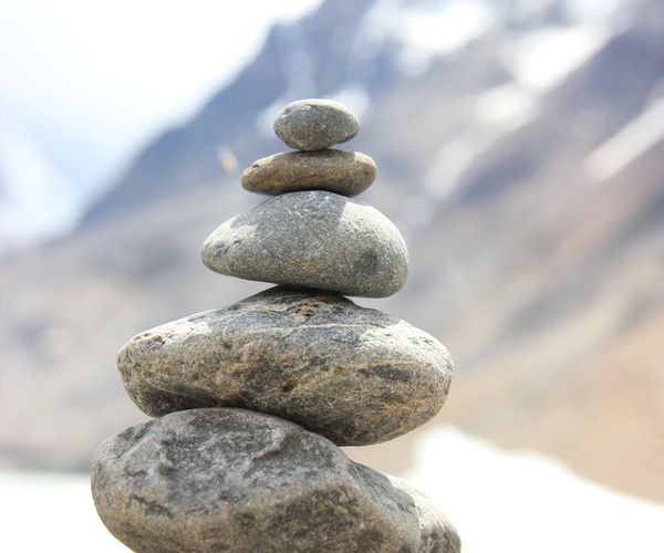 Stack of balanced stones on a blurred natural background.